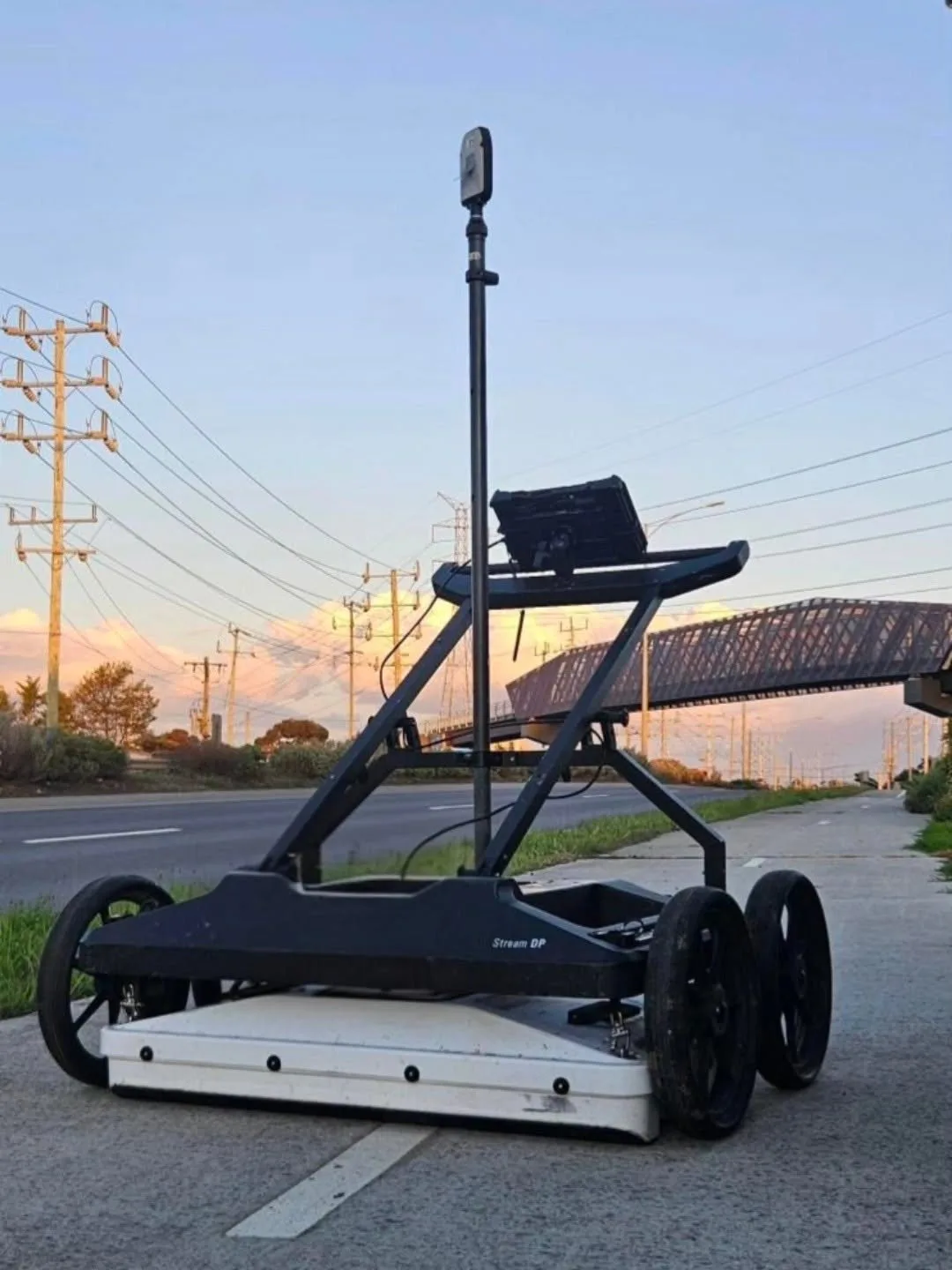 Mobile survey vehicle capturing a road corridor at dusk