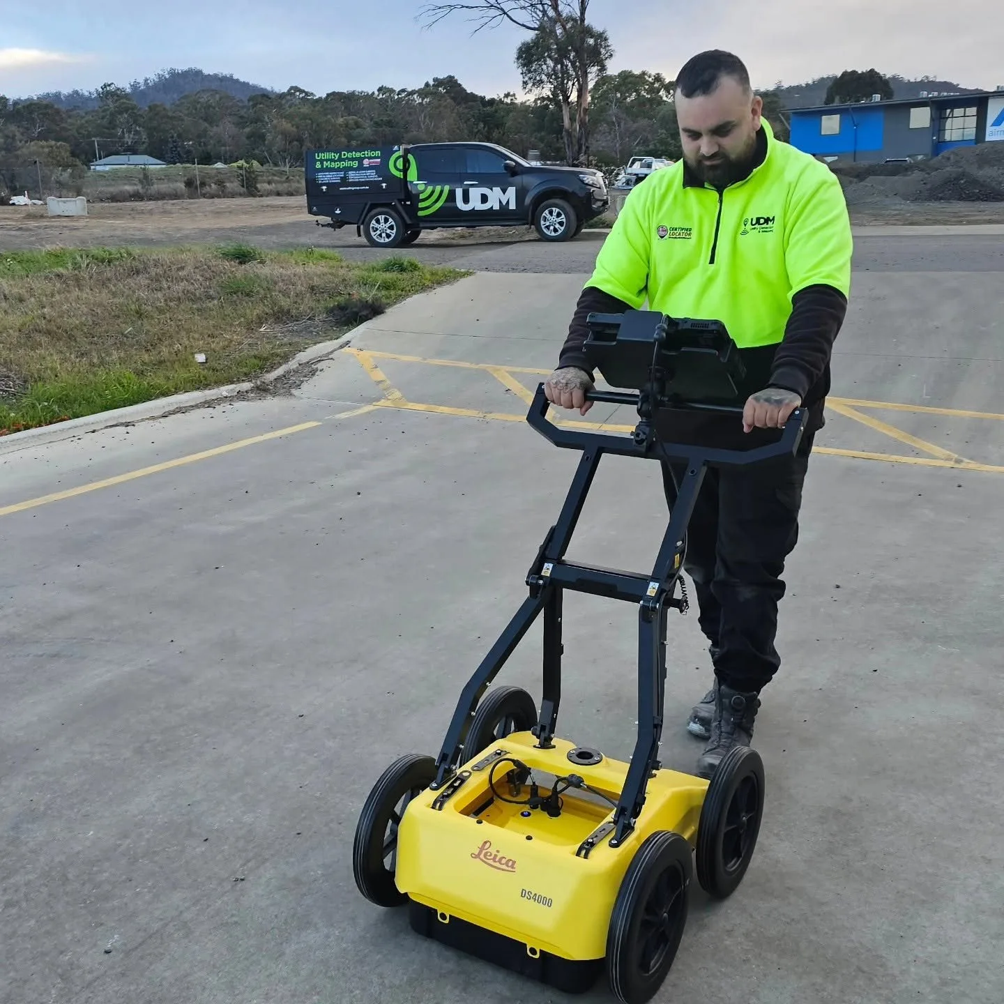 UDM technician walking a ground penetrating radar cart across a sealed surface on a Hobart site